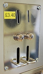 Coin slots on a self-service washing machine